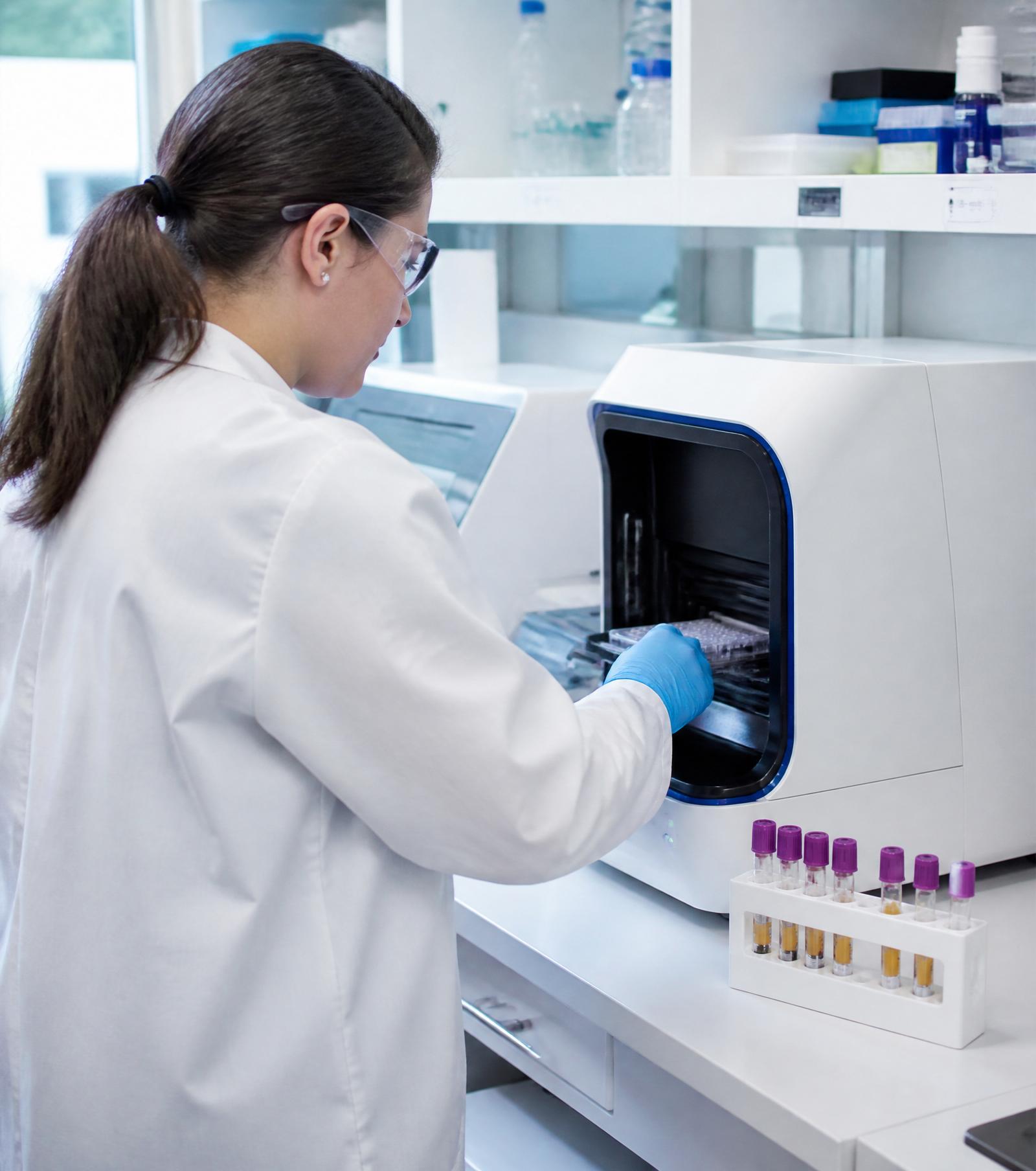 Scientist operating molecular diagnostics instrument